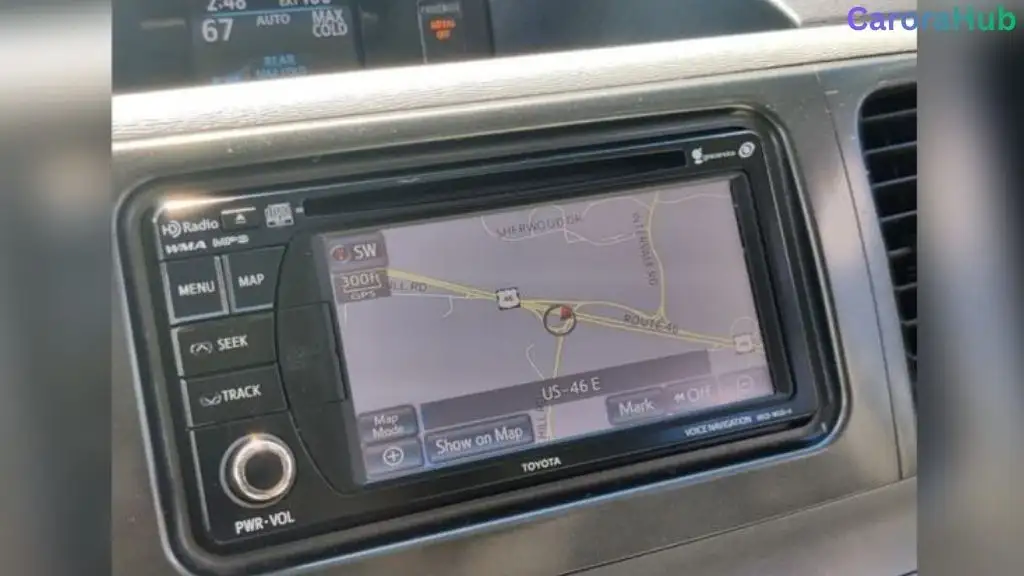 Driver updating Toyota Sienna navigation system on touchscreen