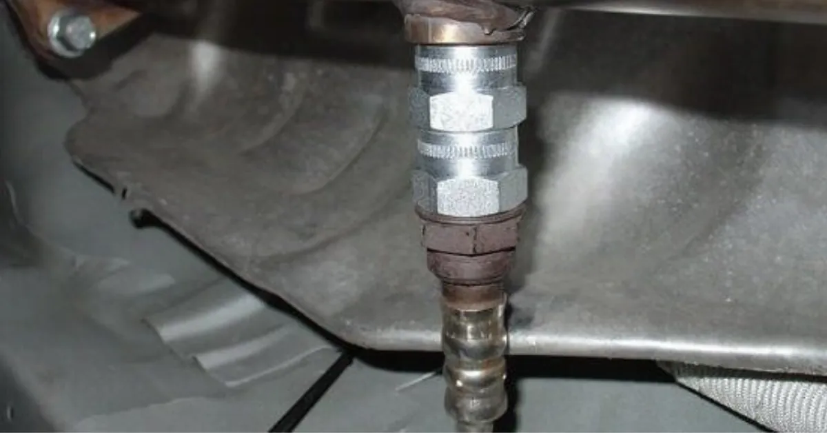 Pouring fresh oil into Prius engine during preventive maintenance