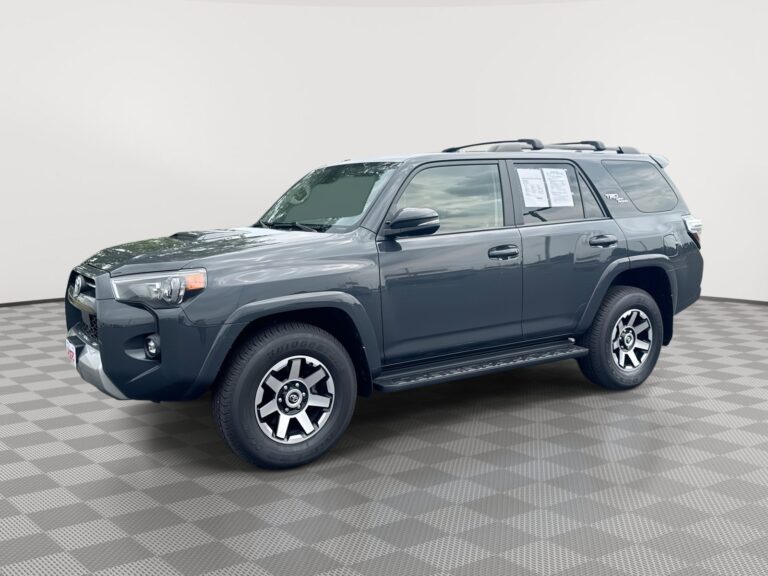 A green antifreeze bottle on a white countertop with a Toyota 4Runner in the background.