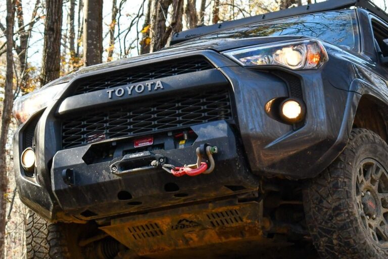 A heavy-duty winch mounted on a Toyota 4Runner in the desert.