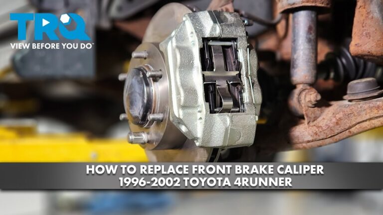 Rusted brake caliper resting on a garage floor near a Toyota 4Runner wheel.